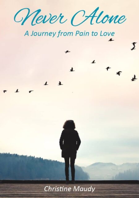 A person standing alone on a dock looking at a misty landscape with birds in flight and the title "Never Alone: A Journey from Pain to Love" with the author's name "Christine Maudy" below.
